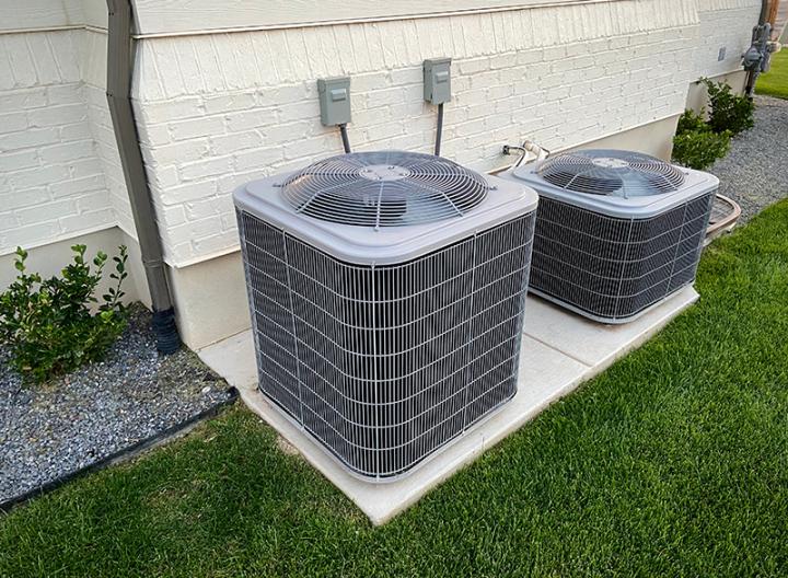 Air conditioner units beside a house.